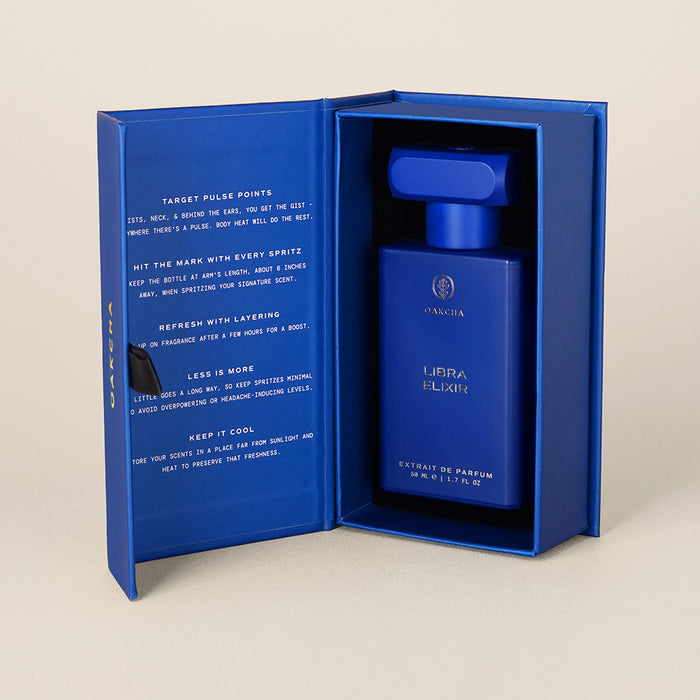 Front view of Libra Elixir 50 ml perfume bottle in matte royal blue inside matching presentation box with booklet text