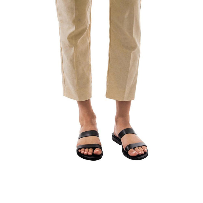 Model wearing Ada black, handmade leather slide sandals