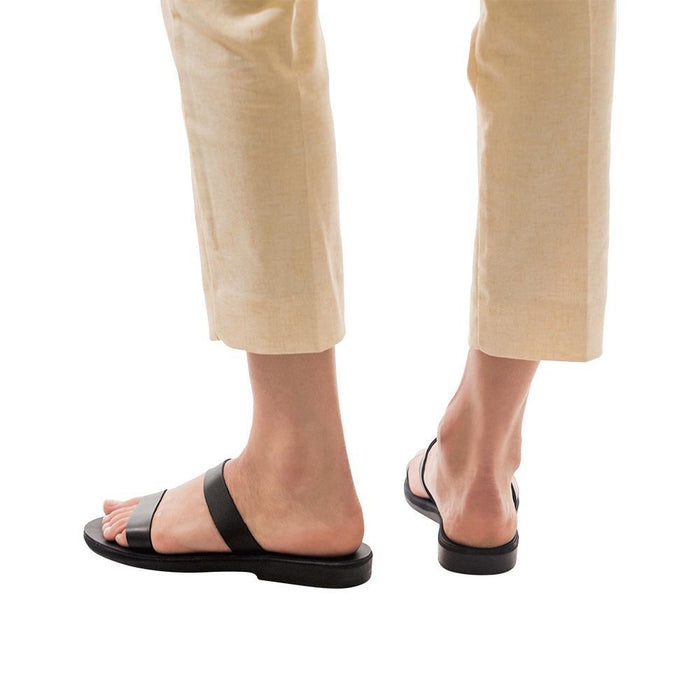 Model wearing Ada black, handmade leather slide sandals