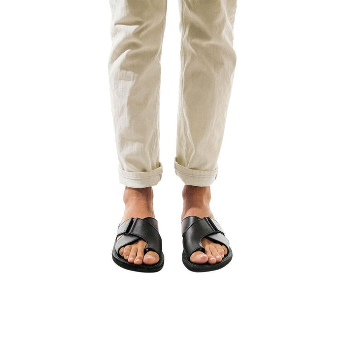 Model wearing Asher black, handmade leather slide sandals with toe loop