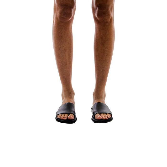Model wearing Bashan black, handmade leather slide sandals