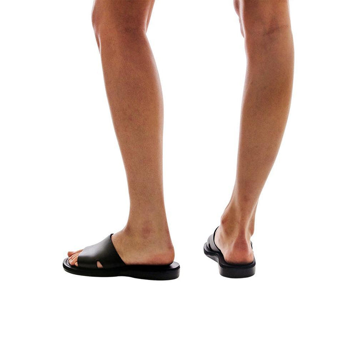 Model wearing Bashan black, handmade leather slide sandals