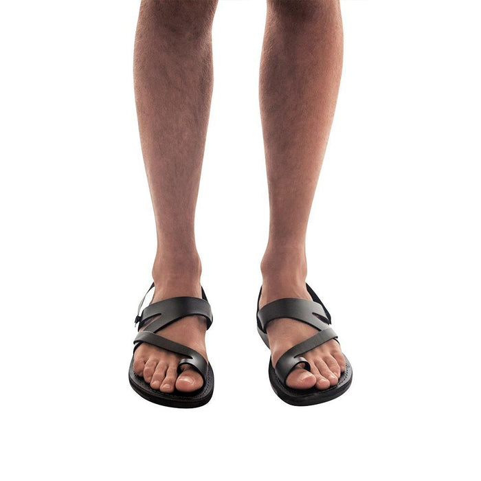Model wearing Benjamin black, handmade leather sandals with back strap and toe loop