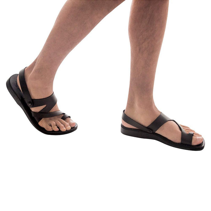 Model wearing Benjamin black, handmade leather sandals with back strap and toe loop