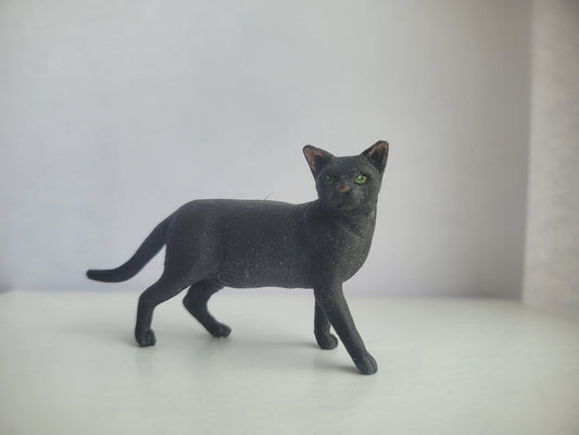 Black cat with Green Eyes Standing - by Karl Blindheim