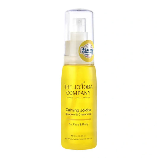 Yellow bottle of The Jojoba Company Calming Jojoba with bisabolol & chamomile on a white background