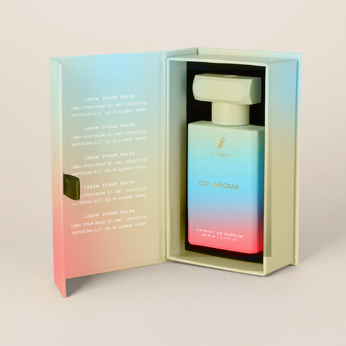 Front view of Colaroma perfume bottle in an open presentation box, showcasing teal-to-pink gradient bottle with gold logo
