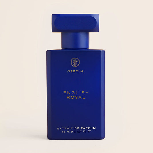 Front view of English Royal perfume bottle with matte blue rectangular bottle, square cap, and gold text on beige background