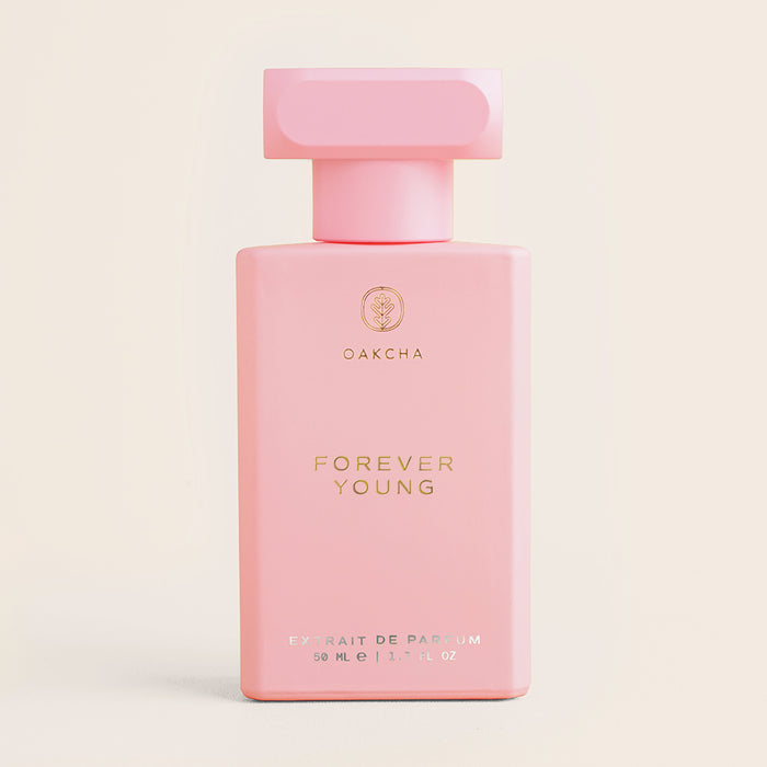 Front view of Forever Young 50 ml perfume bottle, matte pastel pink rectangular with square cap on beige background