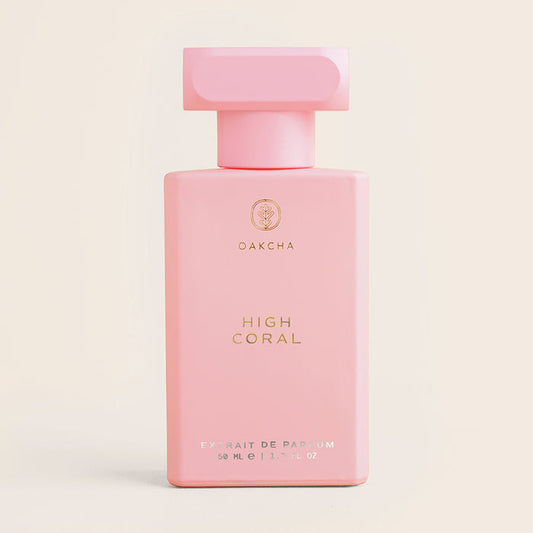 Front view of High Coral perfume bottle showcasing rectangular coral-pink bottle with gold lettering on a neutral beige background