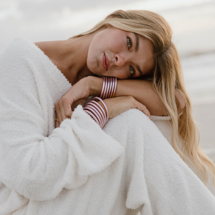 a woman sitting on the beach