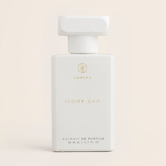 Front view of Ivory Sap 50 ml perfume bottle showcasing matte white rectangular bottle with gold Oakcha logo on a pale beige background