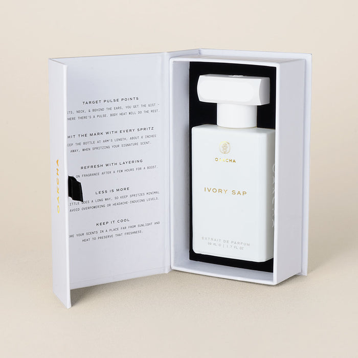 Front view of Ivory Sap perfume in an open white box showing rectangular white bottle with square cap and inner printed flap