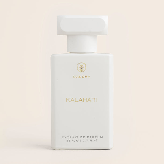 Front view of Kalahari unisex perfume bottle showcasing white rectangular bottle with gold lettering and T-shaped cap on soft beige background