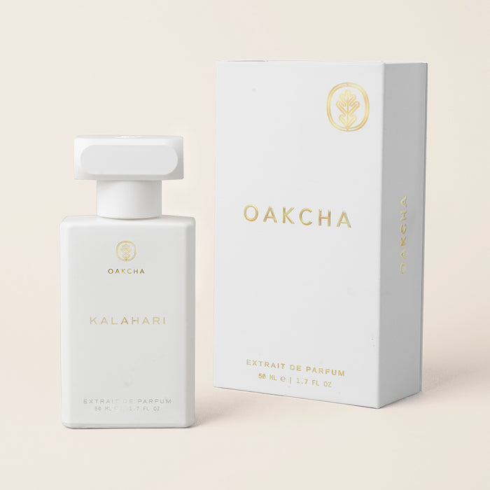 Front view of Kalahari eau de parfum bottle and matching white box showcasing gold Oakcha logo on pale beige background