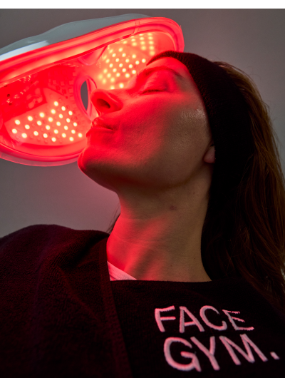 a woman with her eyes closed in a red light