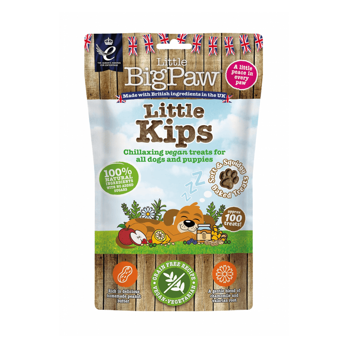 White background with a packet of Little BigPaw 'Little Kips' dog treats. Pictured on the packet is an illustration of a brown dog sleeping with a apples, berries, lemons and a jar of peanut butter in the foreground. Text on the bag says 'Chillaxing vegan treats for all dogs and puppies, 100% natural ingredients, soft & squidgy baked treats. Approx. 100 treats!'