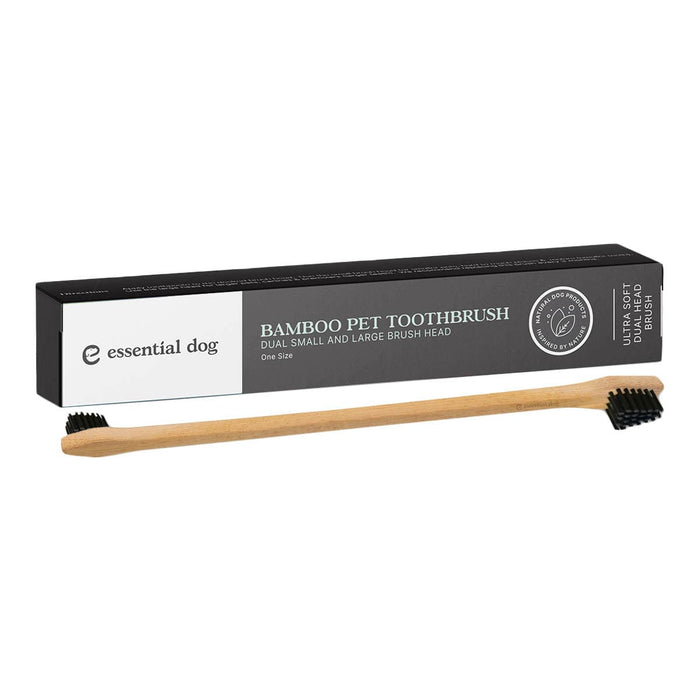 Bamboo pet toothbrush with black bristles and packaging on a white background.