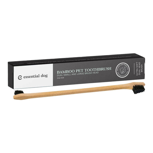 Bamboo pet toothbrush with black bristles and packaging on a white background.