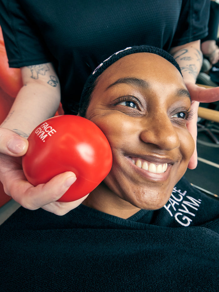 a woman smiling with a red ball