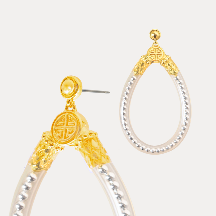 a pair of gold and silver earrings