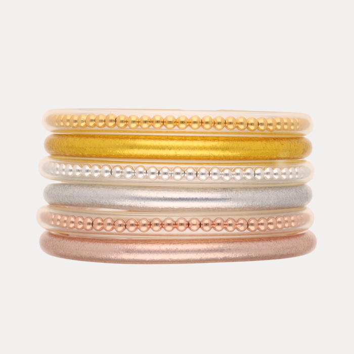 a stack of gold silver and gold bracelets