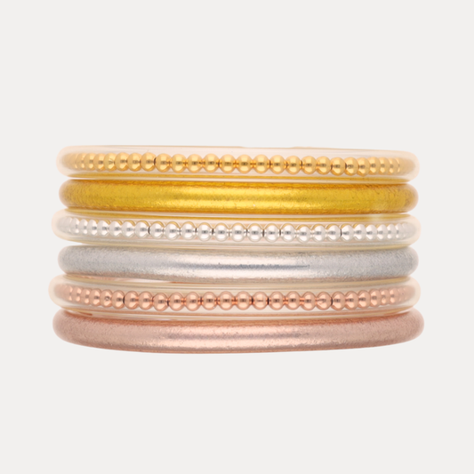 a stack of gold silver and gold bracelets