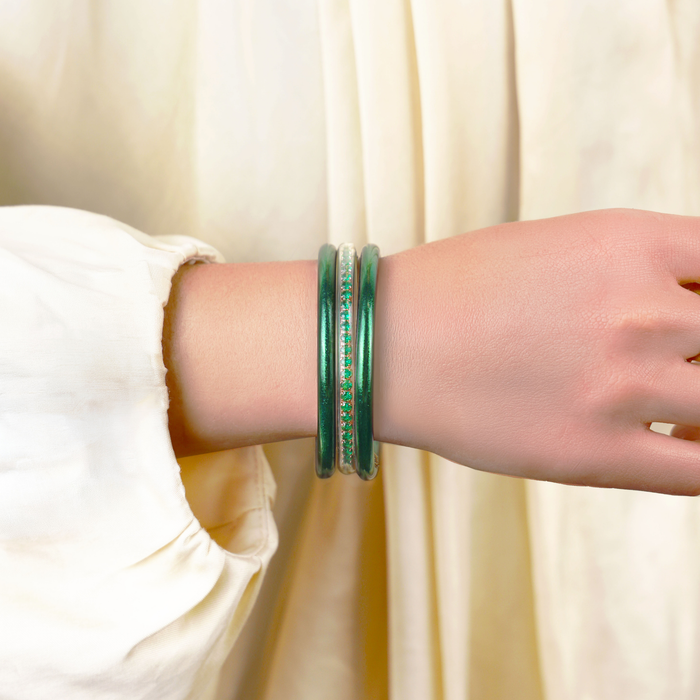 a person wearing green bracelets