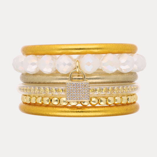 a stack of gold and white bracelets