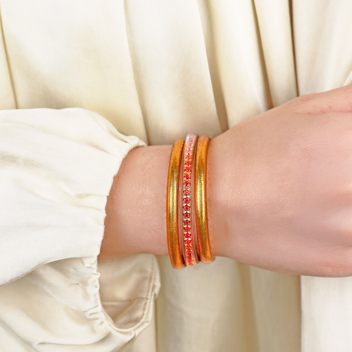 a person wearing gold bracelets