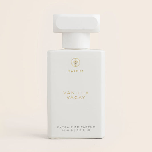 Front of Vanilla Vacay 50ml bottle showing matte white rectangle with square cap and gold Oakcha logo on beige background
