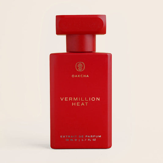 Front view of Vermillion Heat 50 ml perfume bottle, matte red bottle with gold Oakcha logo on light beige background